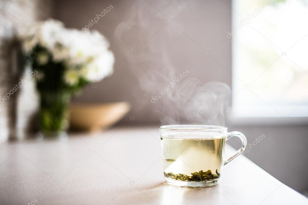 Cup of fresh green tea with steam