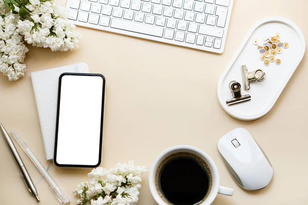 Neutral color tabletop with keyboard, lilac flowers and smartpohone mock-up with white screen isolated — Stockfoto