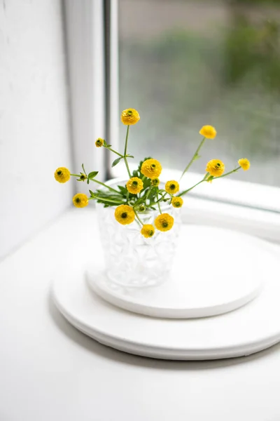 Decoración blanca para el hogar con flores amarillas, jarrón de cerámica y vidrio en bandeja — Foto de Stock