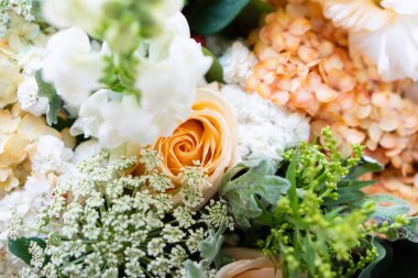 Beautiful floral background, assorted white and beige flowers, bouquer of roses and hydrangeas