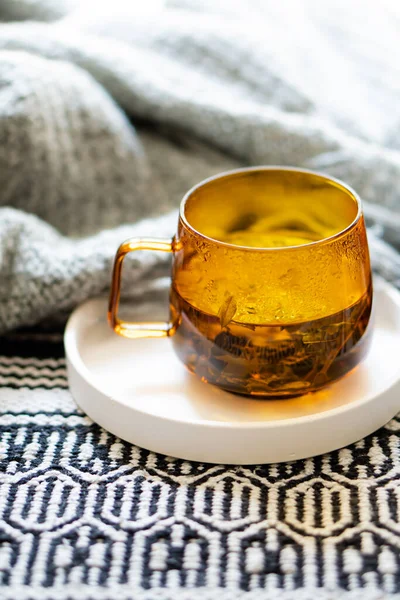 Cup of tea and cozy burning candle on white tray — Stock Photo, Image