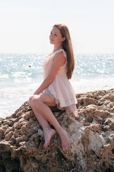 Girl sitting on a rock — Stock Photo, Image