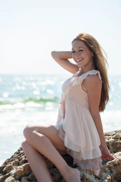 Girl sitting on a rock — Stock Photo, Image