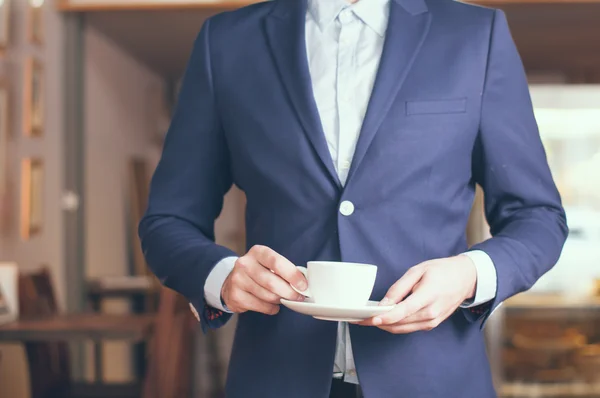 Standing with a cup of coffee — Stock Photo, Image