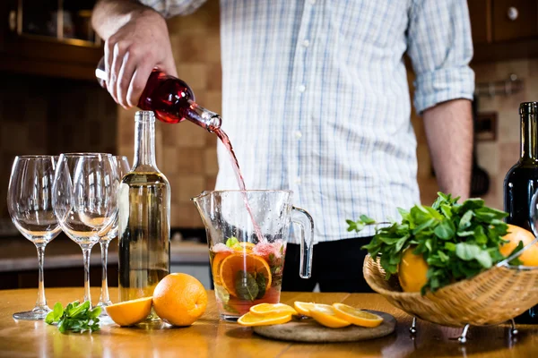 Pouring red wine into a carafe — Stock Photo, Image
