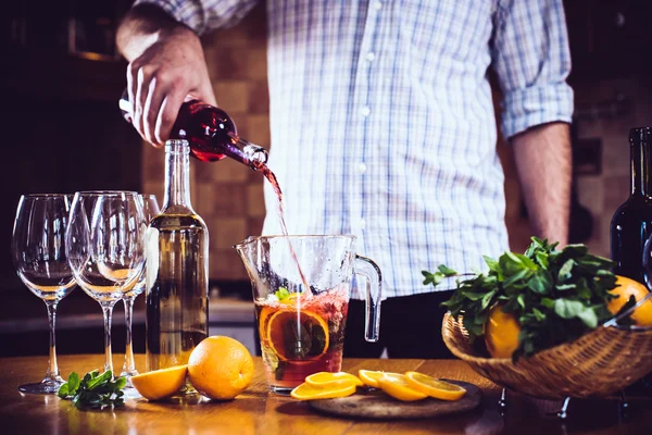 Pouring red wine into a carafe — Stock Photo, Image