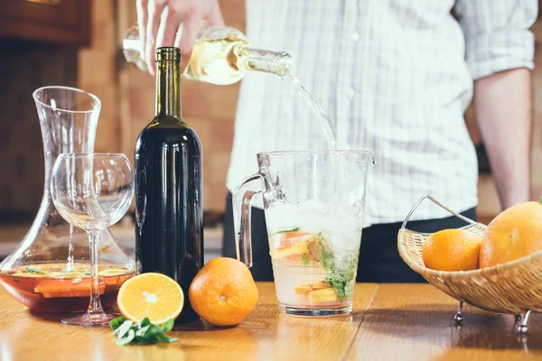 Man pouring white wine into a jar — Stock Photo, Image