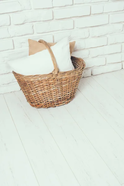 Wicker basket with a pillow — Stock Photo, Image