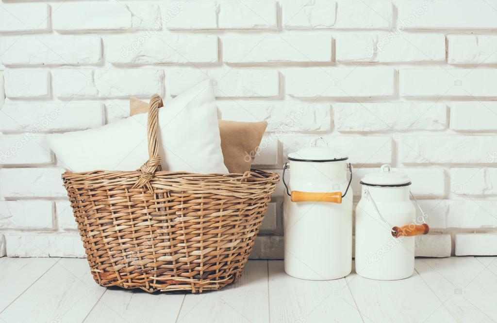 basket with a pillow and milk cans 