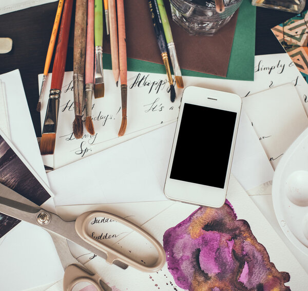 Smartphone on a table in the artist studio