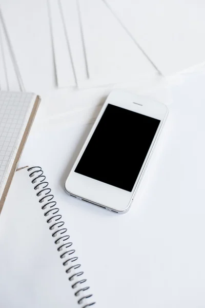 Smartphone and clean white paper — Stock Photo, Image