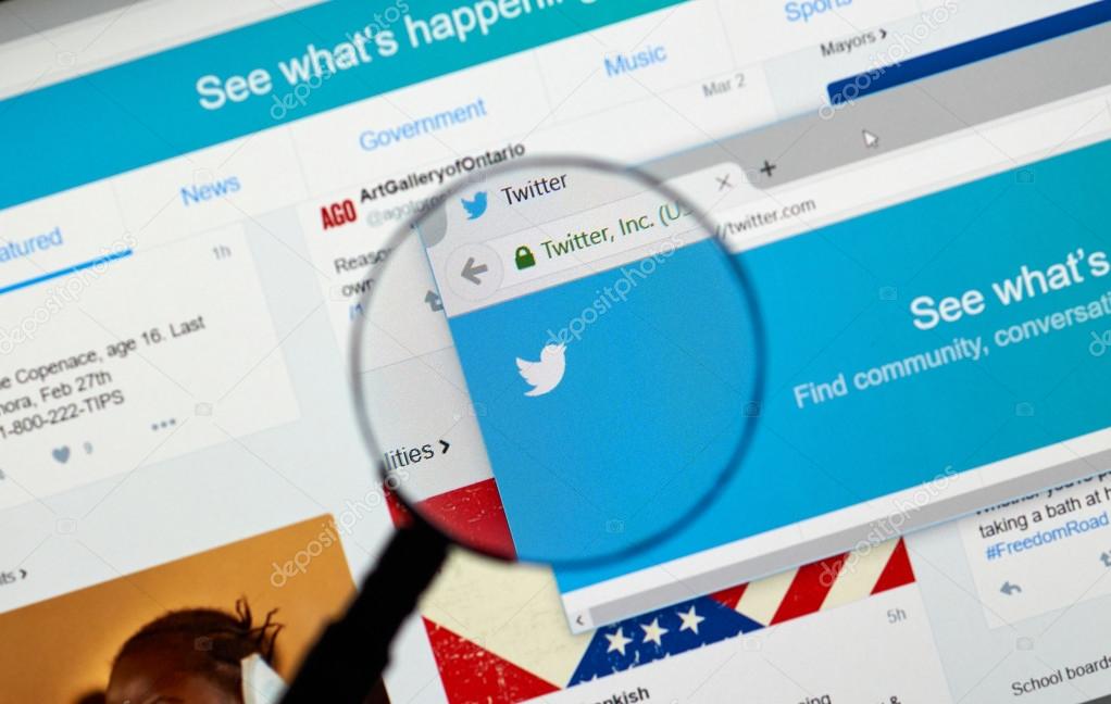 MONTREAL, CANADA - MARCH 3, 2016 - Twitter web page under magnifying glass. Twitter is a well known free social networking microblogging service.