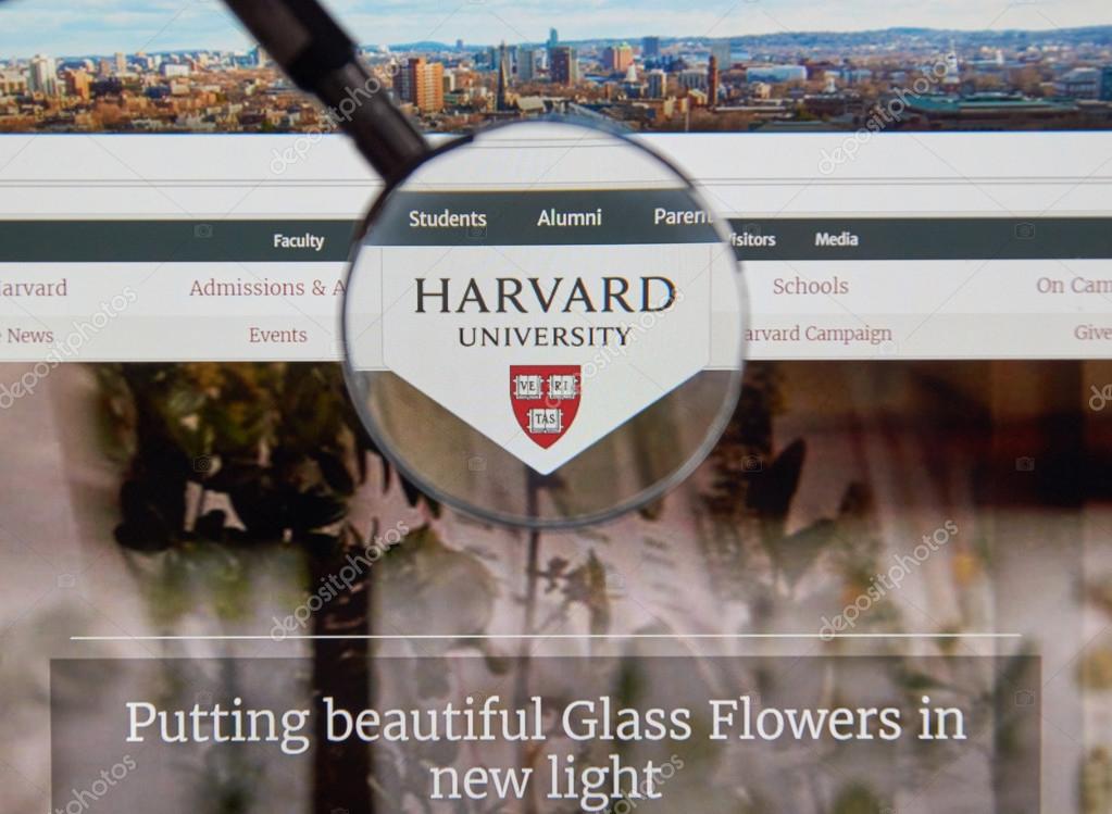 MONTREAL, CANADA - JUNE 4, 2016 : Harvard University page under magnifying glass. Harvard University is a private research university in Cambridge, Massachusetts.