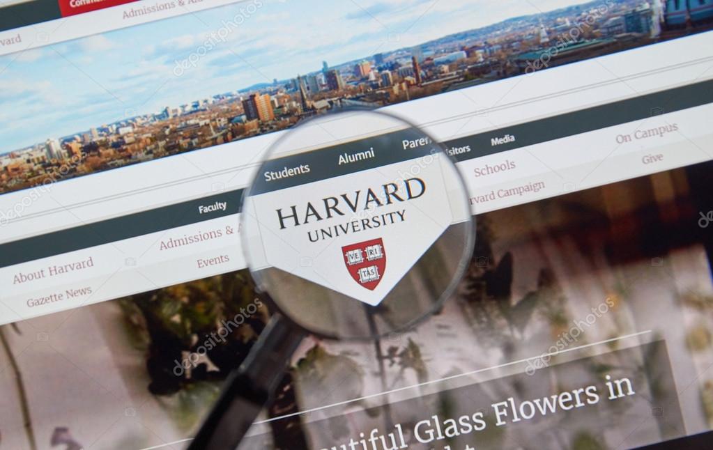 MONTREAL, CANADA - JUNE 4, 2016 : Harvard University page under magnifying glass. Harvard University is a private research university in Cambridge, Massachusetts.