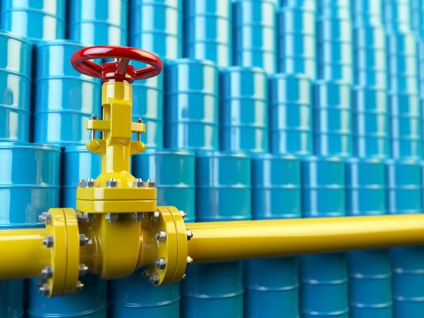 Yellow gas pipe line valves and blue oil barrels. Fuel and energ — Stock Photo, Image