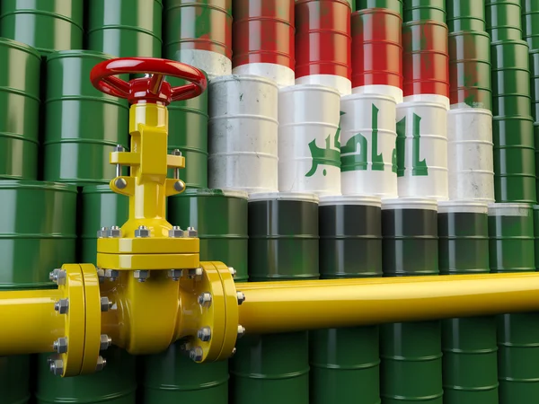 Oil pipe line valve in front of the flag of Iraq on the oil barr — Stock Photo, Image