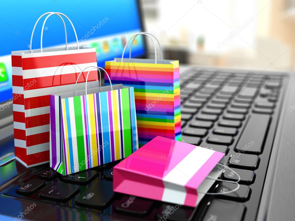 E-commerce. Online internet shopping. Laptop and shopping bags.