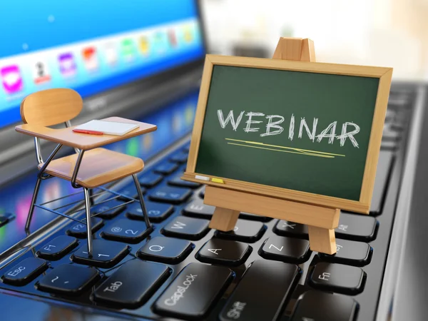 Webinar concept. Desk and chalkboard on the laptop keyboard. Rechtenvrije Stockafbeeldingen