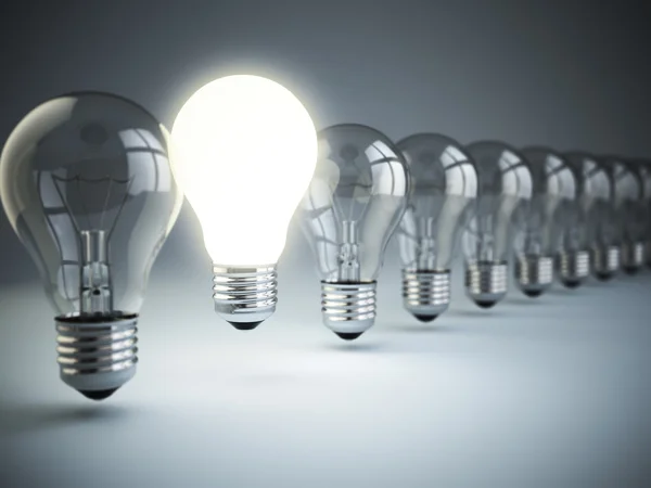 Idea or uniqueness, originality concept. Row of light bulbs with — Stock Photo, Image