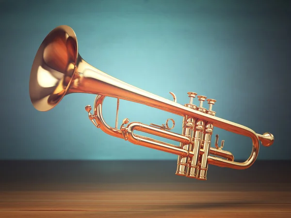 Polished brass trumpet on green background. — Stock Photo, Image