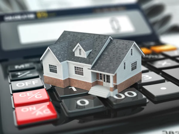 De calculator van de hypotheek. Woning op knoppen. Onroerend goed concept. Stockfoto