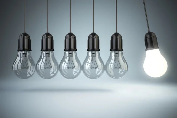 Light bulbs and perpetual motion. Idea o creativity concept. — Stock Photo, Image