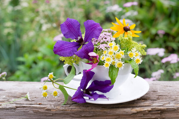 bouquet of summer flowers in a cup