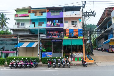 Motorbikes parking and old colorfull apartment block