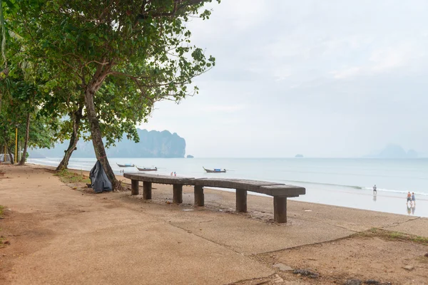 Long wooden bench by the seaside — Stock Photo, Image