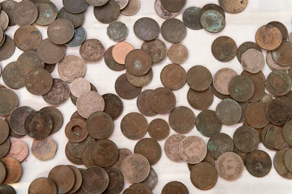 Assortment of Old Burmese Coins on a White Background Stock Image