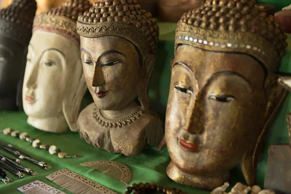 Buddha heads on a shop shelf — Stock Photo, Image