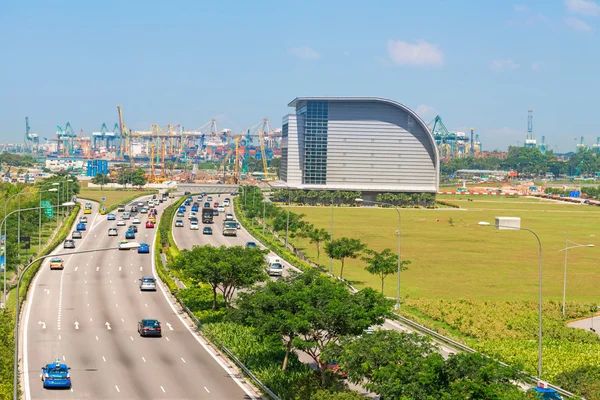 Car traffic with Singapore cargo port on background. — Stock Photo, Image