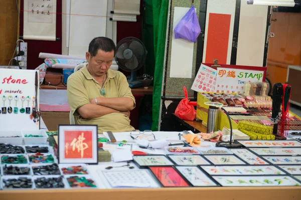Individual stamps resting seller on his store — Stock Photo, Image