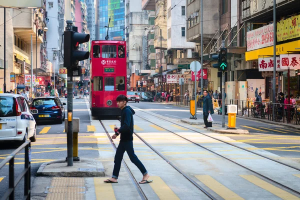 Fußgänger überquert eine typische, viel befahrene Straße in Zentral-Hongkong, — Stockfoto