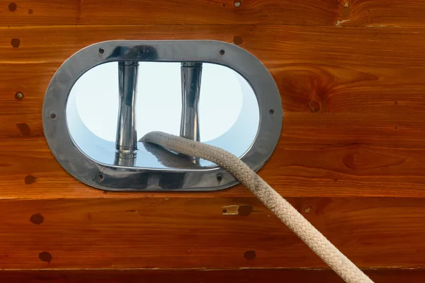 Stainless steel fairlead on a wooden yacht — Stock Photo, Image
