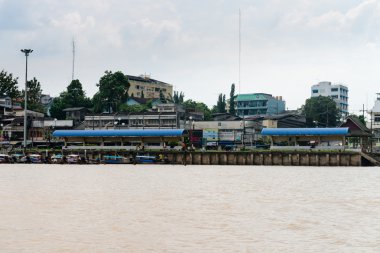 Shaded waiting benches along a passenger boat dock in Krabi, Tha
