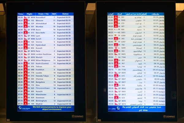 Digital schedule board announcing flight arrival times at Dubai — Stok fotoğraf