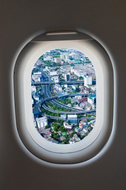 Airplane window from interior of aircraft with high way view. clipart