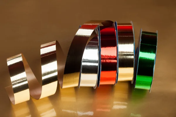 Festive ribbons on a reel — Stock Photo, Image
