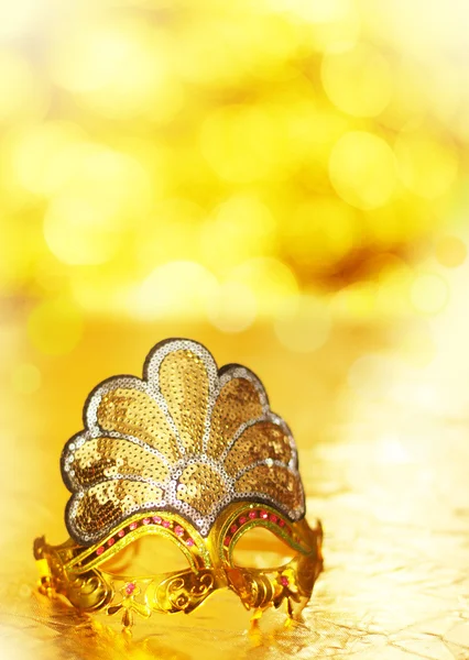 Carnival gold venetian mask on golden background — Stock Photo, Image