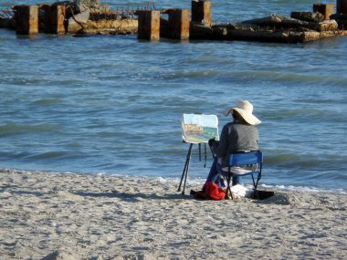 Deniz kenarındaki bir sanatçı bir resim çizer. Kazakistan. Aktau. Mangistau bölgesi. 01 Ekim 2019.