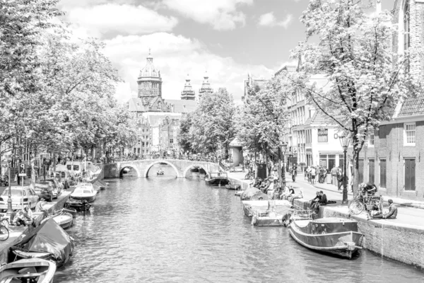 Touristen auf einem Kanal in Amsterdam — Stockfoto