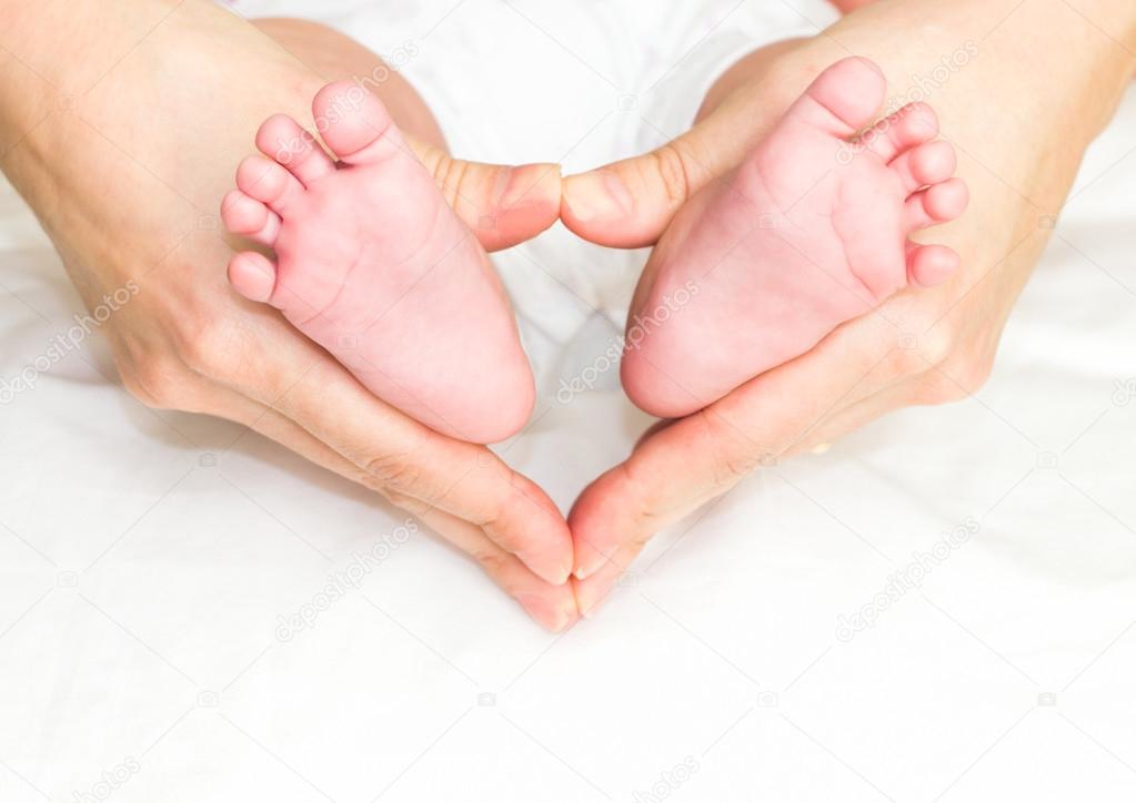 Baby's feet in mother's hand