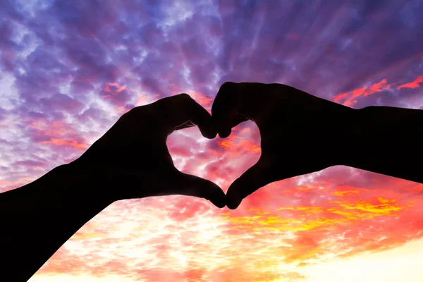 Silhouette hand in heart shape and beautiful sky — Stock Photo, Image