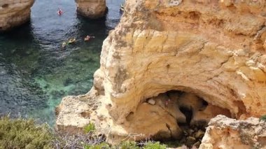 Algarve, Portekiz - 19 Ağustos 2023: Marinha sahilindeki Fil Kayası 'nın yanındaki güzel teknenin tadını çıkaran insanlar. Avrupa 'nın en güzel 10 plajından biri olarak kabul edilir ve dünyanın en iyi 100 plajından biridir.