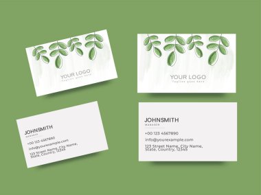 Önünde ve arkasında yeşil yapraklar olan bir çift iş ya da ziyaret kartı.