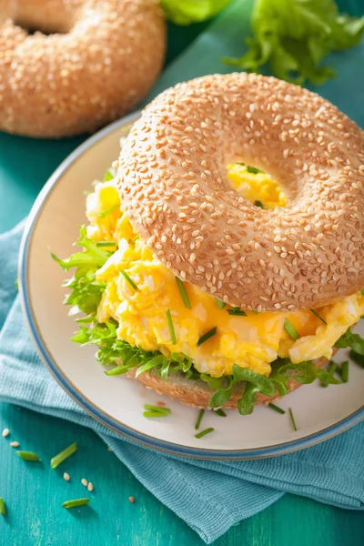 Breakfast sandwich on bagel with egg cheese lettuce — Stock Photo, Image