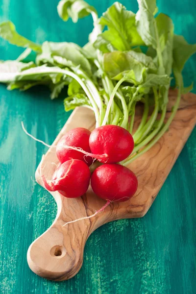 Fresh radish with leaves over green background — Stock Photo, Image