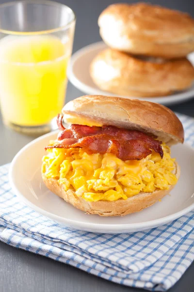 Breakfast sandwich on bagel with egg bacon cheese — Stock Photo, Image