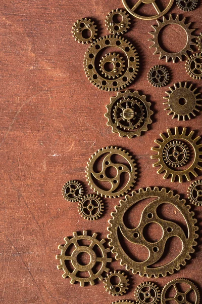 Steampunk mechanical cogs gears wheels on wooden background — Stock Photo, Image